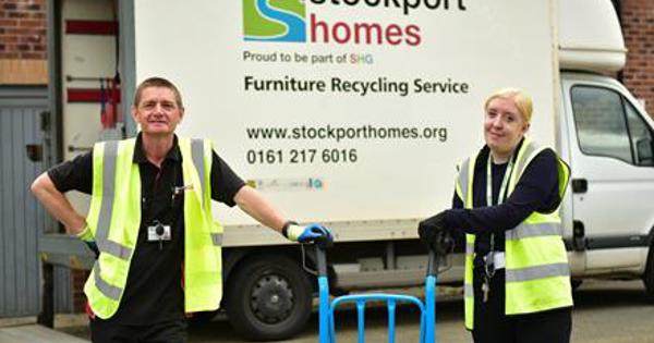 Woman and man in hi-viz in front of Stockport Homes van