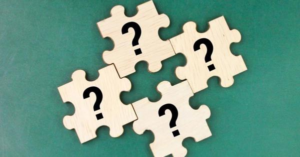 Question marks on wooden jigsaw blocks