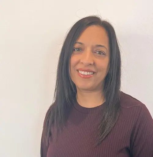 Nasrin Fazal wearing a purple shirt