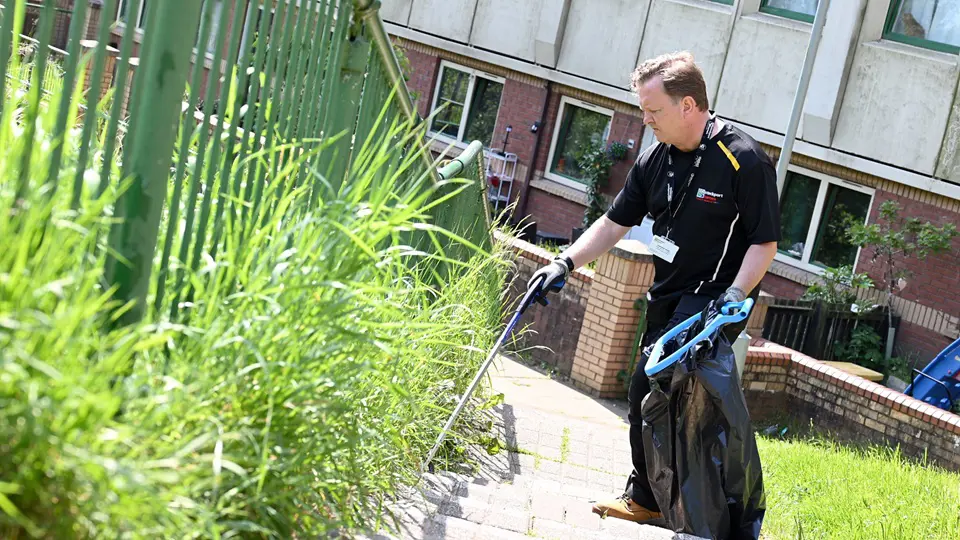 Caretaker Picking Up Litter