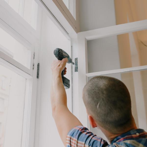 Man drilling in window