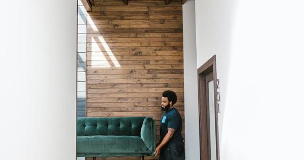 Side shot of men moving a couch into a home