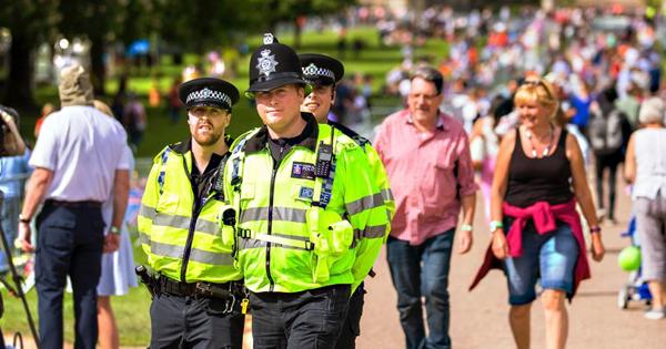 two Police officers in a park full of people
