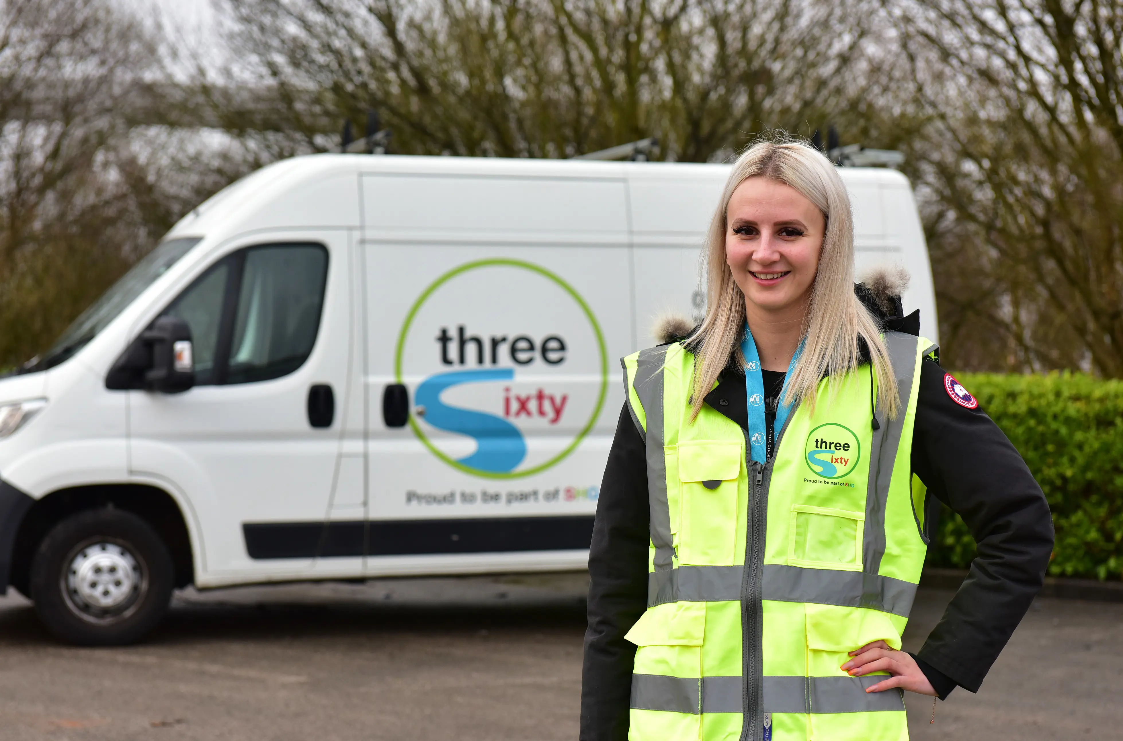 Woman in a hi-viz in front of a three sixty branded van