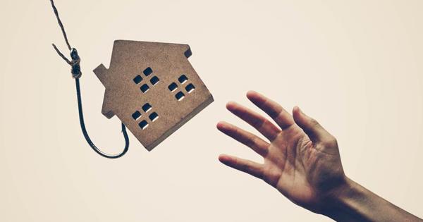 Wooden house on fishing line with hand reaching to it