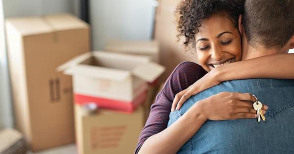 Happy couple in new home with boxes in the background