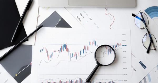 graphs on paper with magnifying glass 