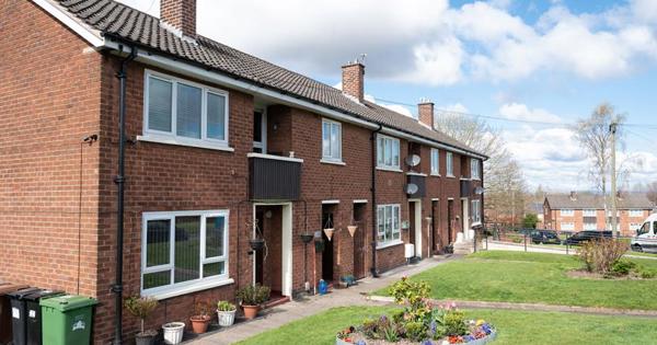 View of a row of houses converted into flats with gardens at the front. 