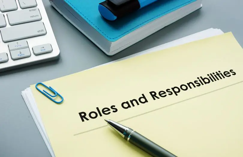 Roles and responsibilities as text on a notepad with a pen on top