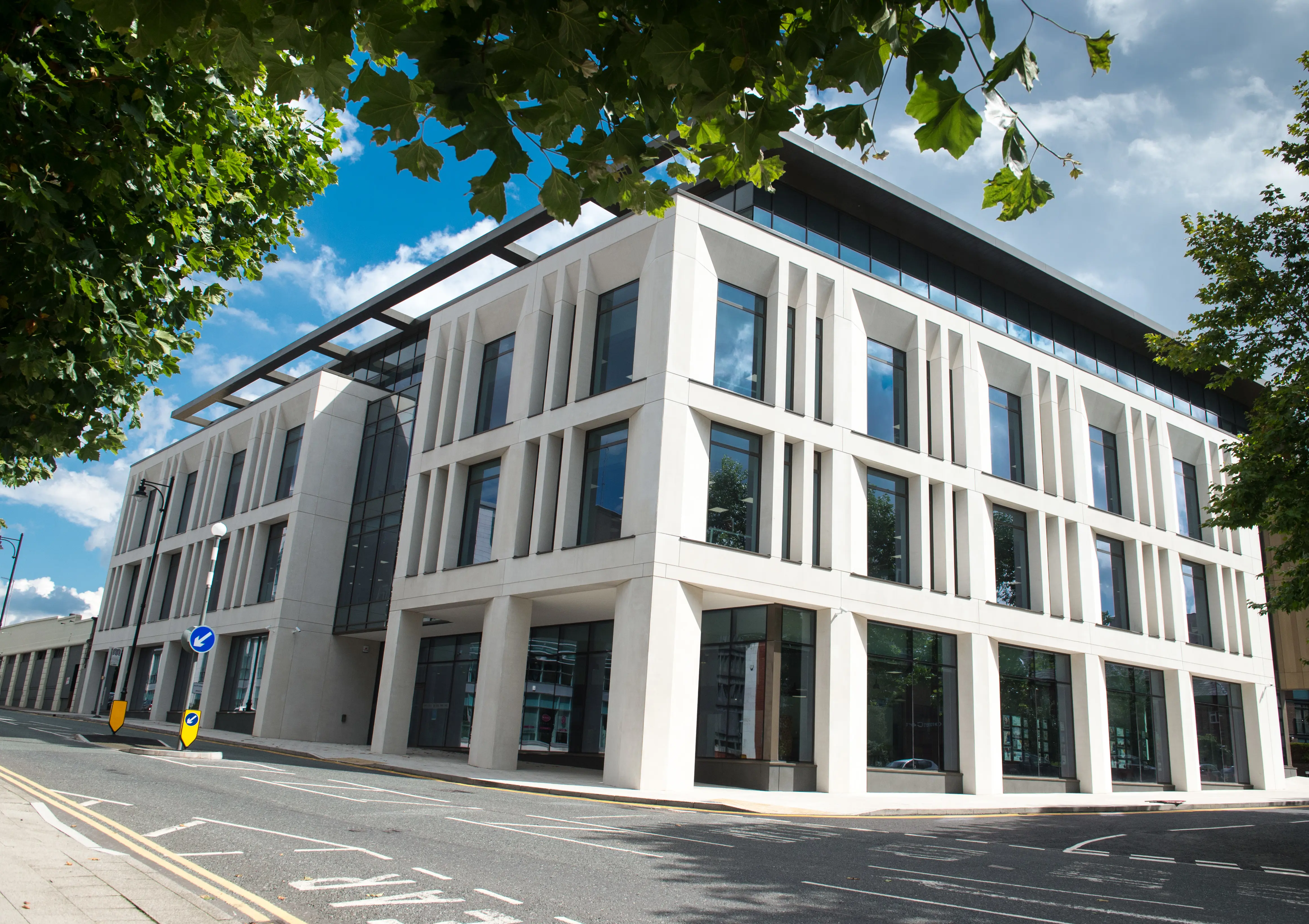 front view of large office building with many glass windows
