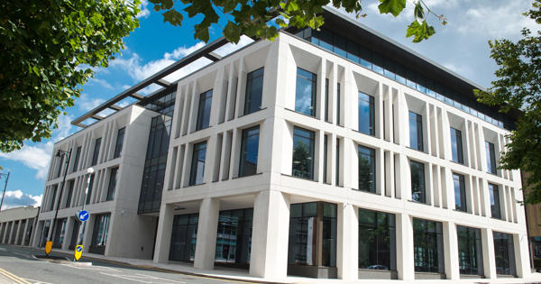 front view of large office building with many glass windows