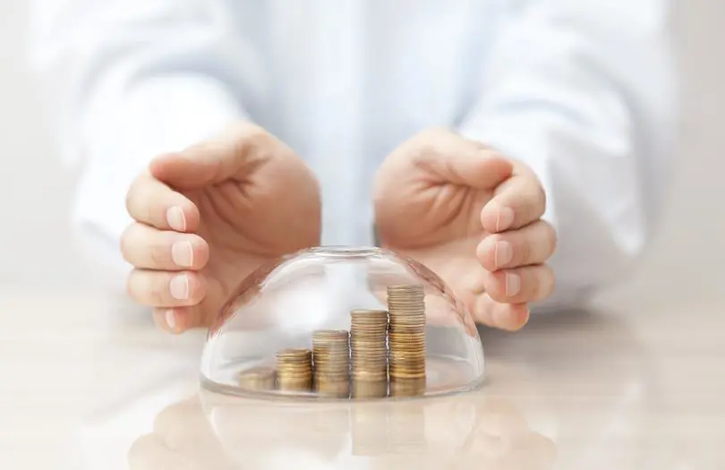 hands covering coins