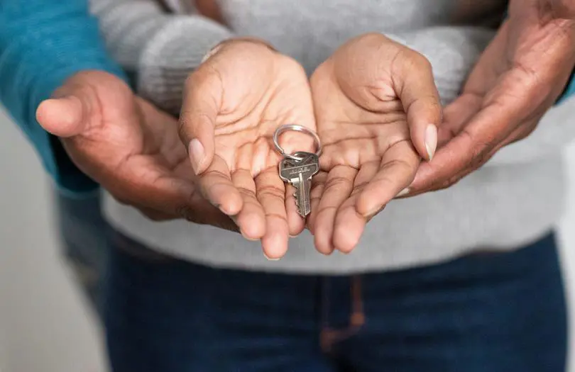 Two sets of Hands Holding Key