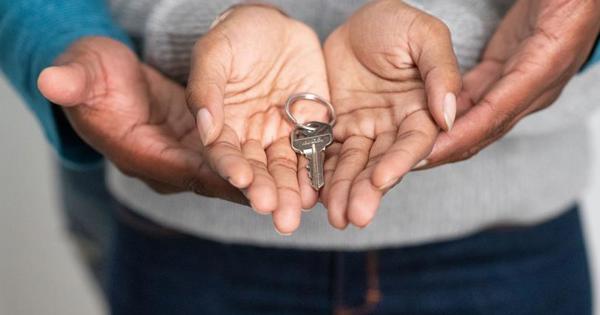 Two sets of Hands Holding Key