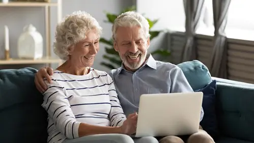 Older Couple On Sofa With Laptop