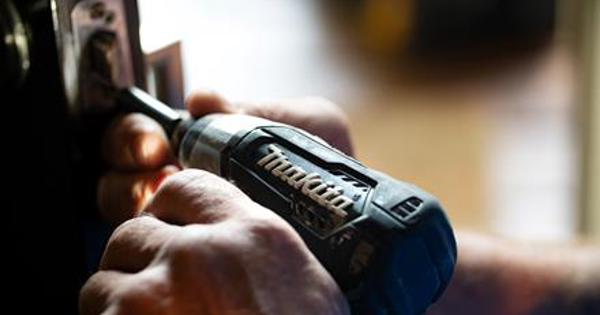 drill putting a screw into a frame