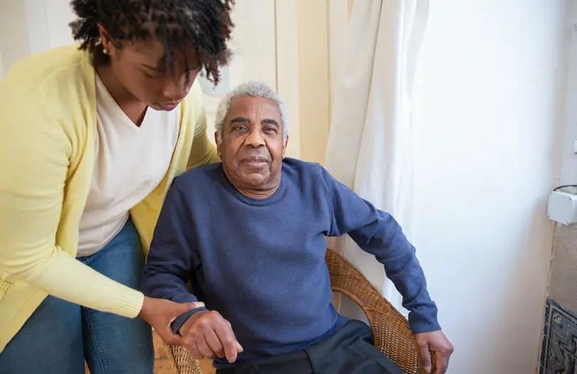 Older man being helped by woman