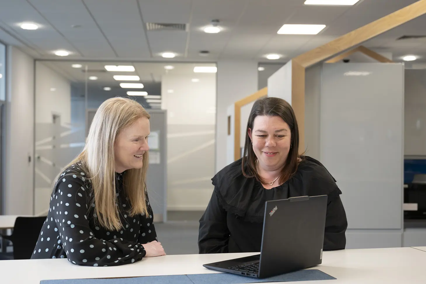 Two Females Looking At Laptop