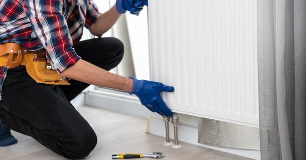 A person putting on a radiator to a wall