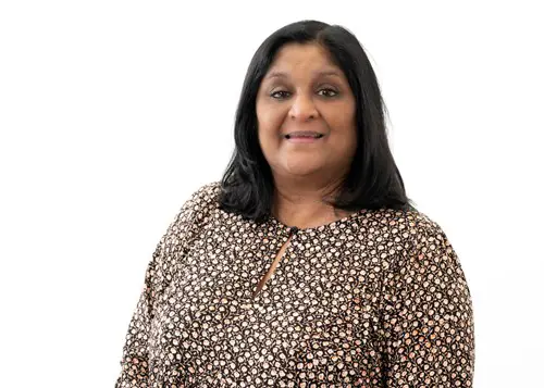 Priti Butler headshot with dotted shirt