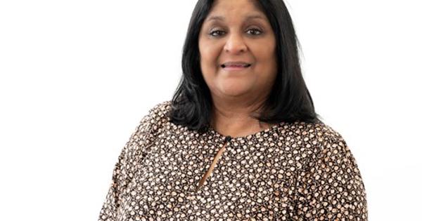 Priti Butler headshot with dotted shirt