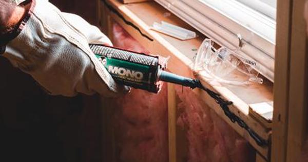 hands gluing windowsill