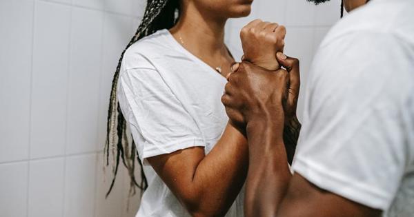 man holding up woman against a wall