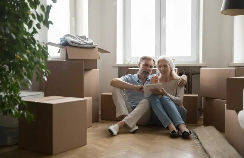 happy couple in a house with cardboard boxes