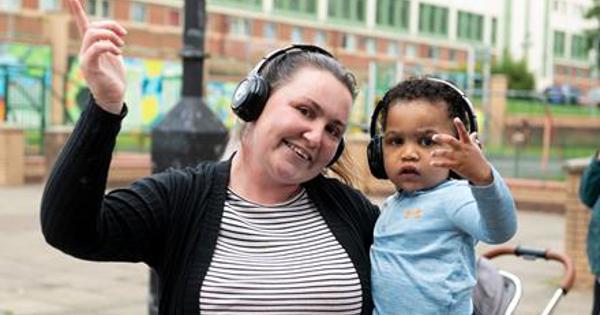 Happy child and woman with headphones on
