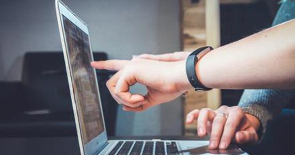 Fingers pointing to laptop screen
