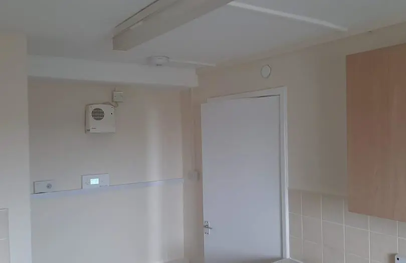 A sprinkler in a white room 