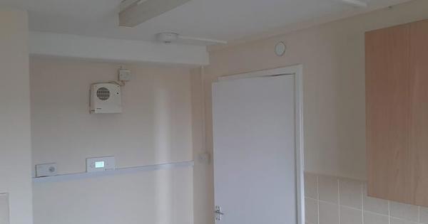 A sprinkler in a white room 