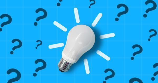 white light bulb against a blue background with black question marks across the background