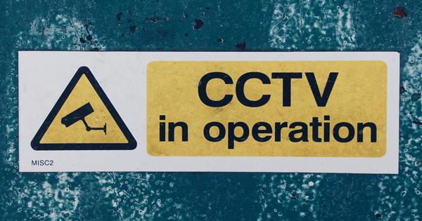 CCTv in operation sign on blue wall