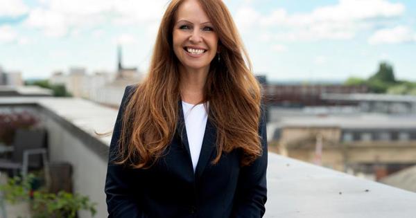Carmel Chambers profile outside on balcony wearing a jacket