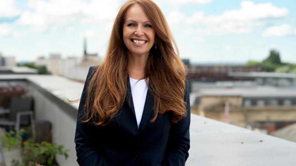 Carmel Chambers profile outside on balcony wearing a jacket