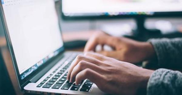 hand typing on laptop