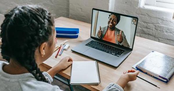 Woman having a meeting with another woman on a video call with a laptop