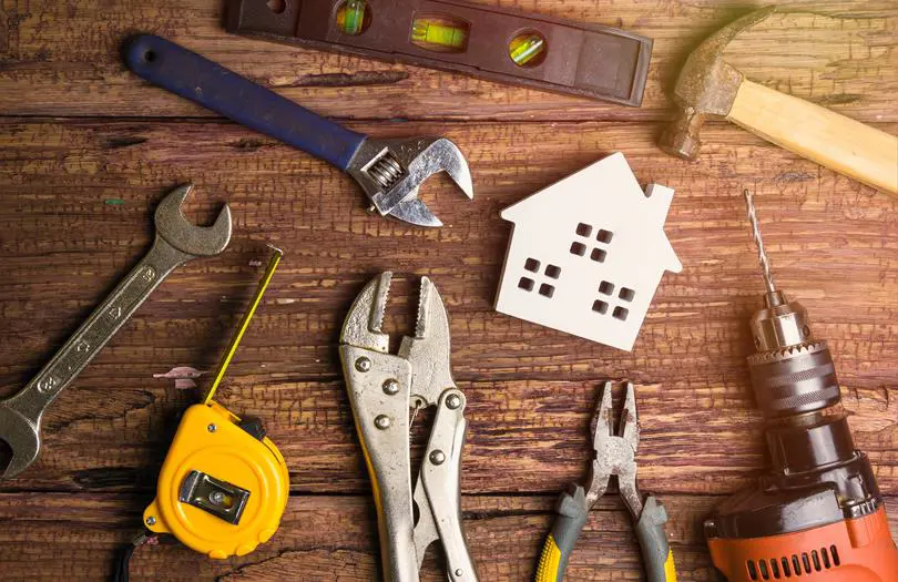 tools on a table with wooden house 