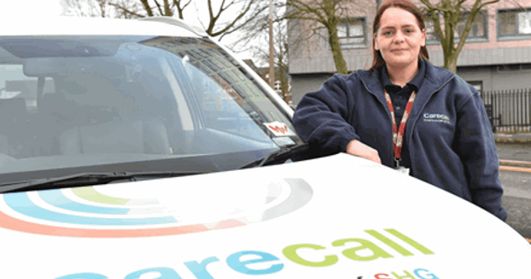 Woman at the side of a carecall car