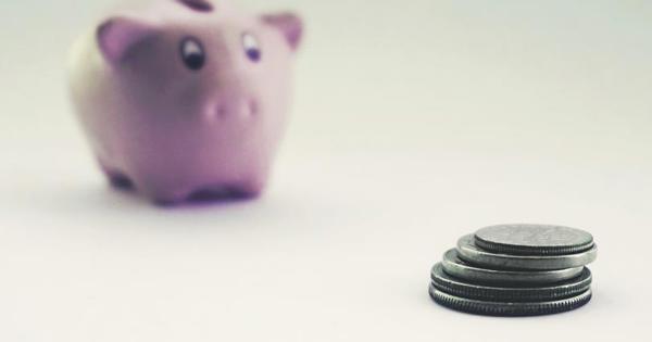 pink piggy bank next to coins