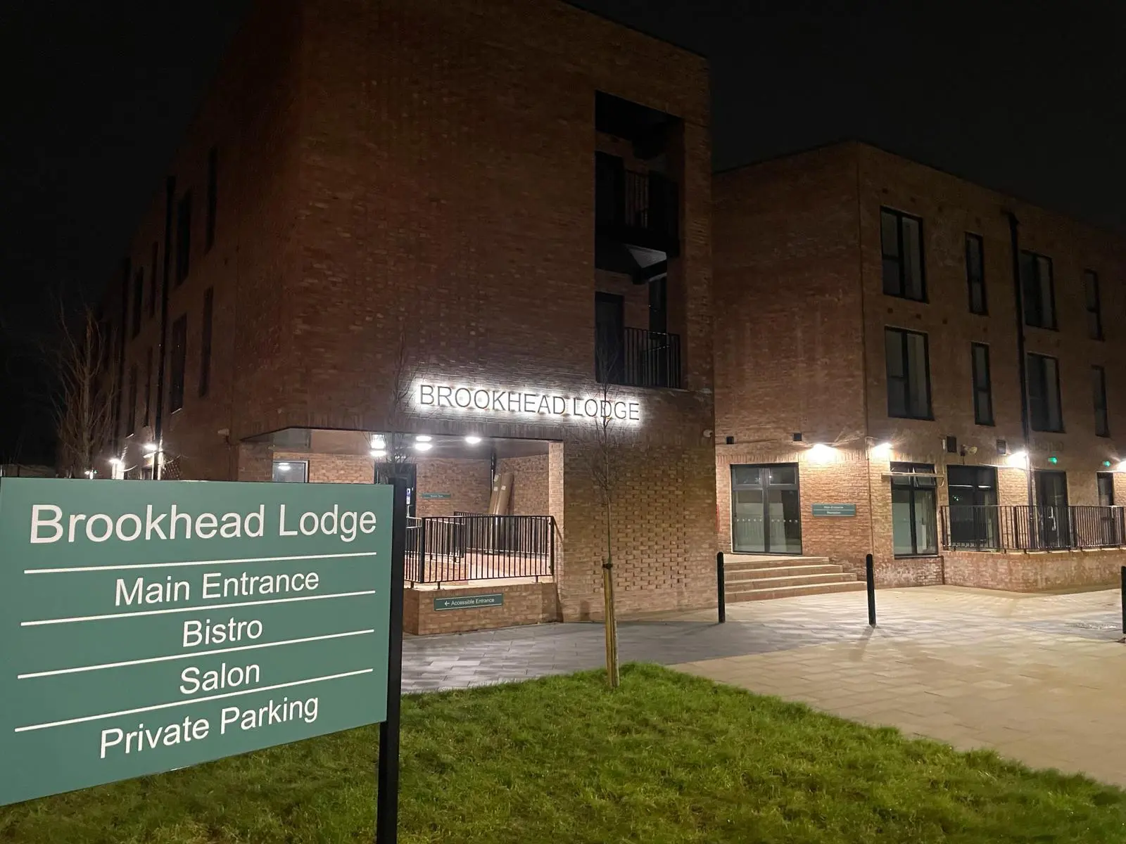 exterior of outside building of Brookhead Lodge showing a sign and building name in lights