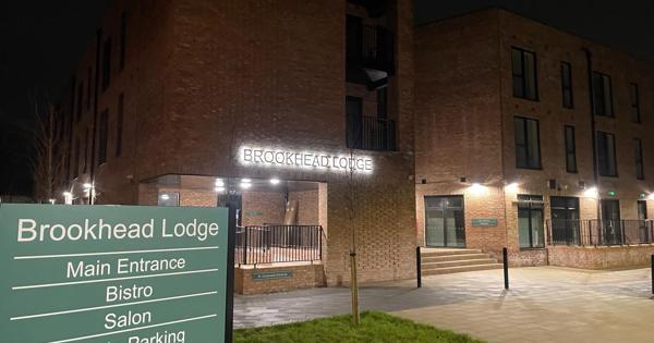 exterior of outside building of Brookhead Lodge showing a sign and building name in lights