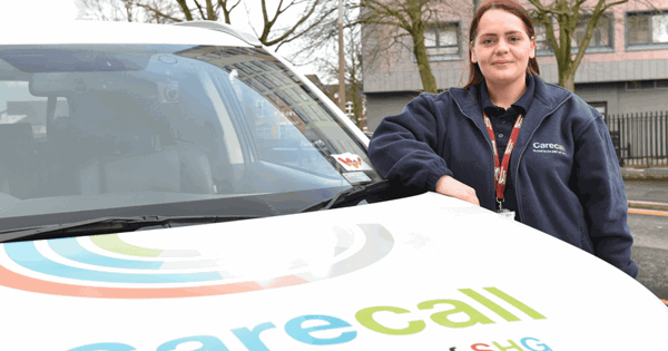 Woman at the side of a carecall car