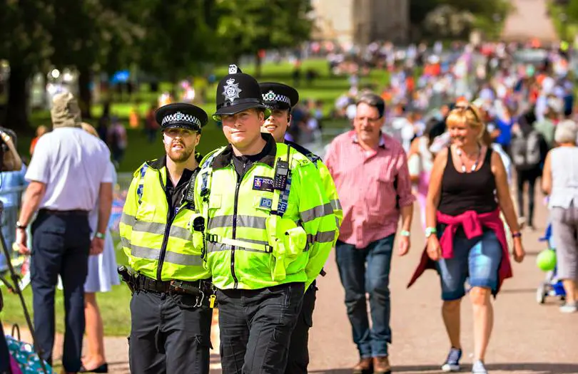 two Police officers in a park full of people
