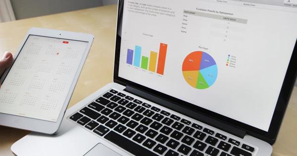 Stats show on a laptop with mobile to side