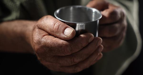 close up hands holding a metal mug 