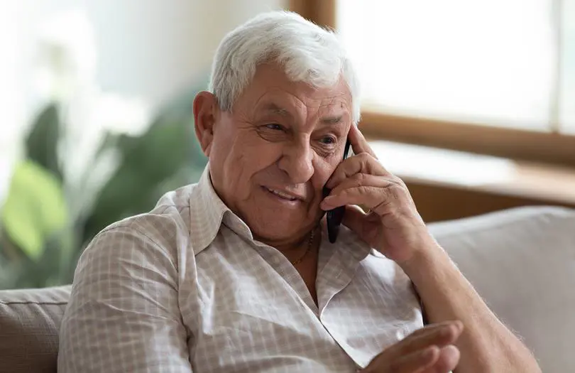 Older Man In Home on a mobile phone