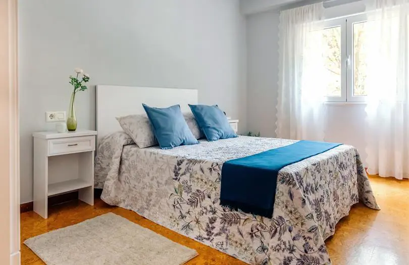 inside of bedroom with blue pillows