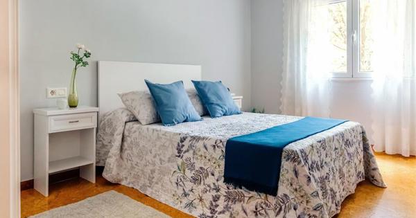 inside of bedroom with blue pillows